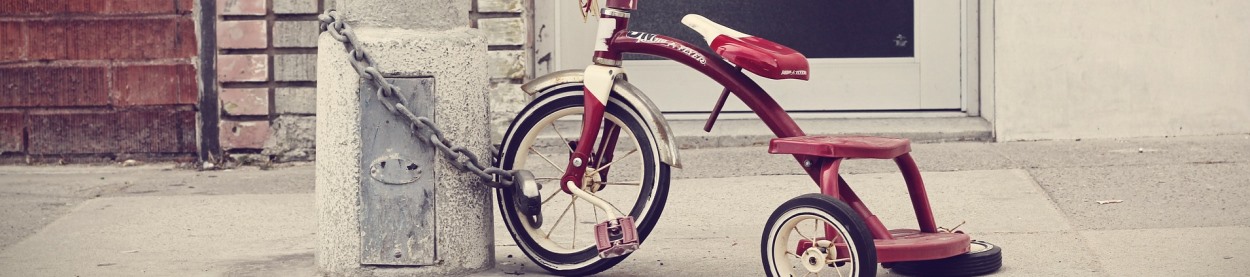 Photo of a tricycle chained to a light pole